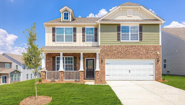 view of front of house featuring a garage, a porch, and a front lawn