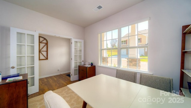 home office featuring hardwood / wood-style flooring and french doors