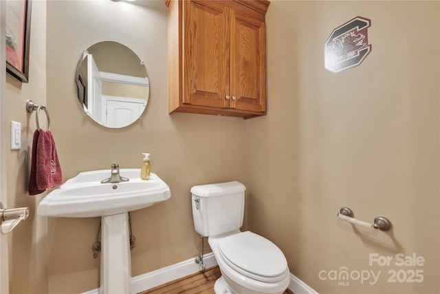 119 Era St, Troutman, NC 28166 - bathroom with baseboards, toilet, wood finished floors, and a sink