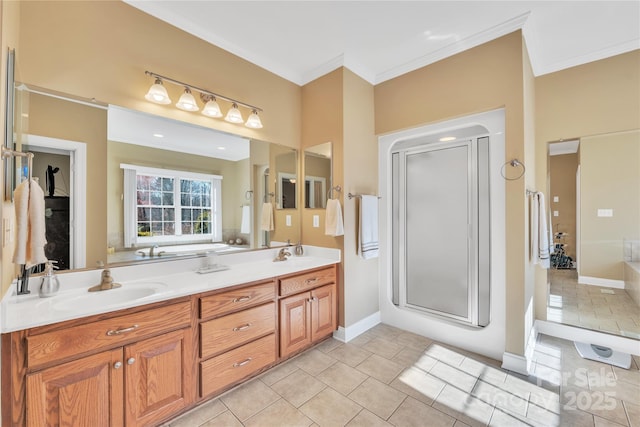 119 Era St, Troutman, NC 28166 - bathroom featuring ornamental molding, tile patterned flooring, double vanity, a stall shower, and baseboards