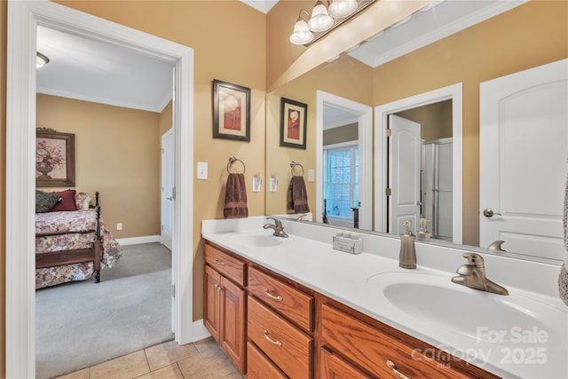 119 Era St, Troutman, NC 28166 - ensuite bathroom featuring ornamental molding, double vanity, tile patterned flooring, and baseboards