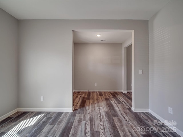 unfurnished room featuring dark wood-type flooring