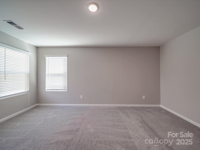 spare room with light colored carpet