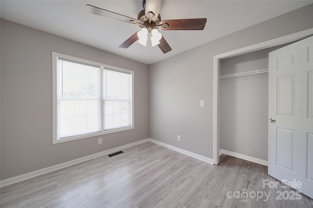 unfurnished bedroom with visible vents, baseboards, ceiling fan, light wood-type flooring, and a closet