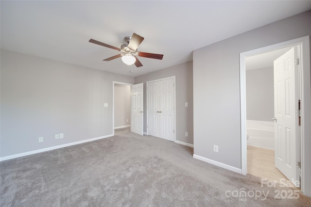 unfurnished bedroom with a closet, light carpet, ceiling fan, and baseboards