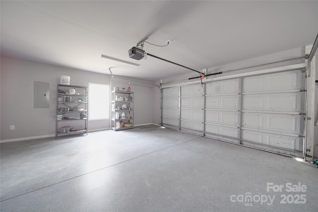 garage featuring baseboards, electric panel, and a garage door opener