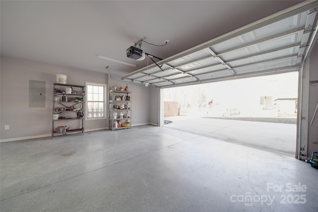 garage featuring electric panel, baseboards, and a garage door opener