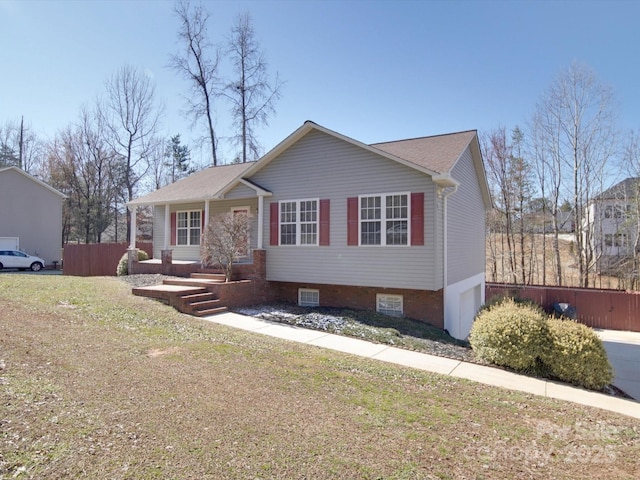 view of front of property featuring a garage, fence, and a front lawn