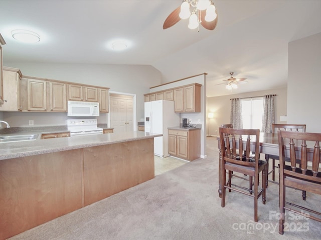 kitchen featuring white appliances, light countertops, a sink, and light carpet