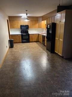 kitchen with a ceiling fan, baseboards, light countertops, black appliances, and brown cabinetry