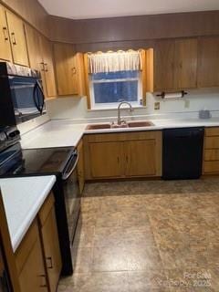 kitchen with black appliances, light countertops, and a sink