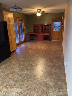 unfurnished living room with a ceiling fan