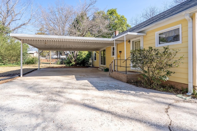 view of parking / parking lot featuring a carport