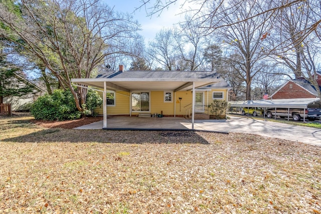 back of house with a yard and a carport