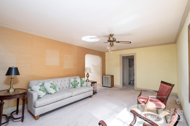 living room with ceiling fan, crown molding, and carpet flooring