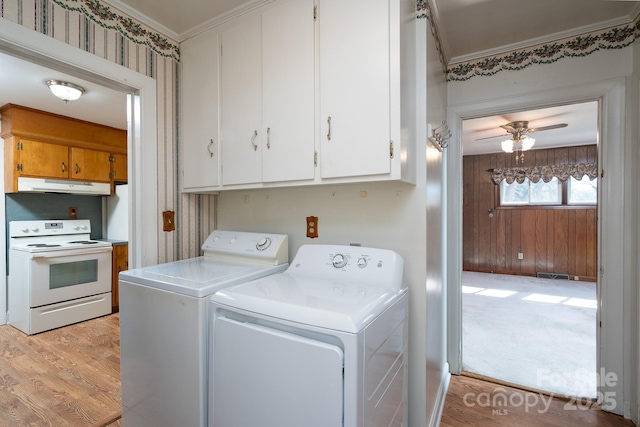 laundry room with cabinets, light hardwood / wood-style floors, ornamental molding, ceiling fan, and separate washer and dryer