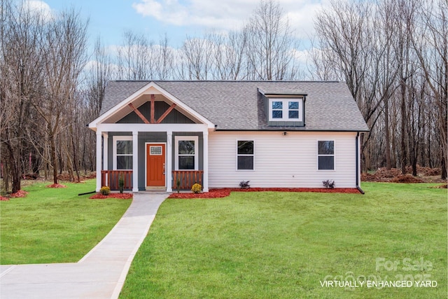 view of front of property featuring a shingled roof, a front yard, and board and batten siding