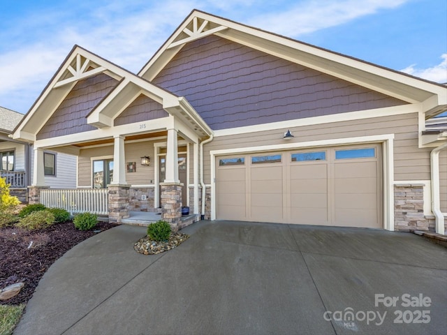 craftsman house with a garage and covered porch