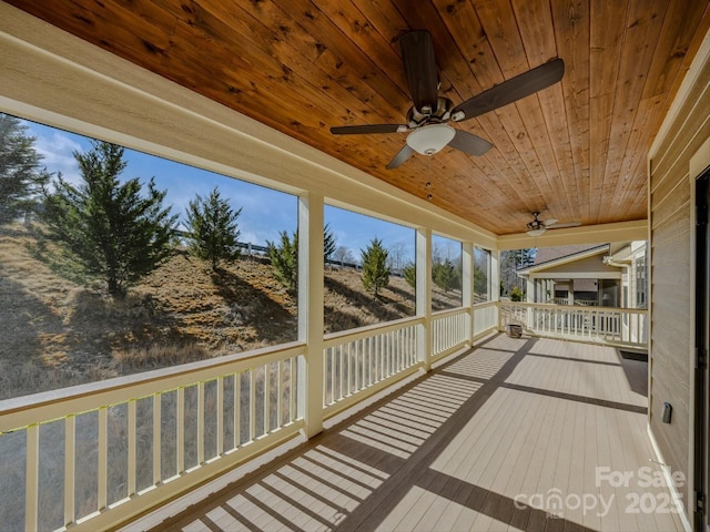 wooden deck featuring a porch and ceiling fan