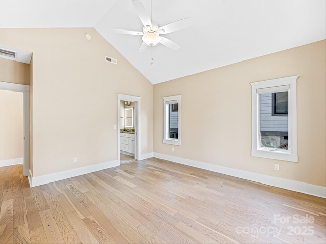 empty room featuring ceiling fan, high vaulted ceiling, and light hardwood / wood-style flooring