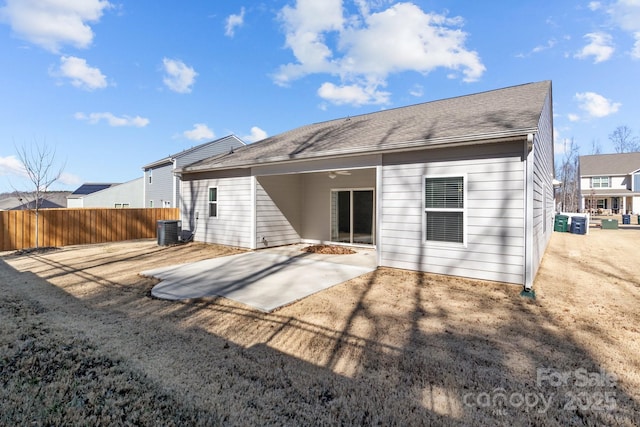 rear view of house with central AC unit, a patio area, and fence