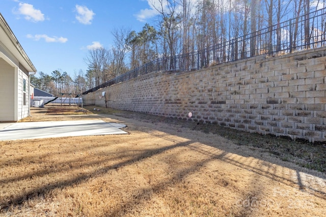 view of yard with fence and a patio