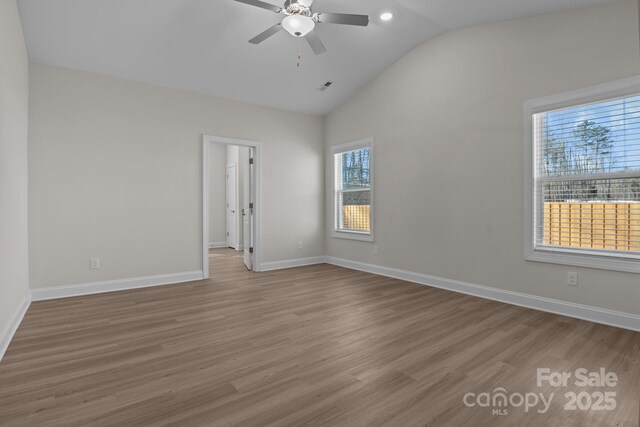 unfurnished room with baseboards, ceiling fan, wood finished floors, and visible vents