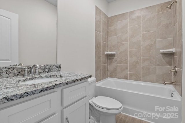 full bath featuring shower / bathtub combination, vanity, toilet, and wood finished floors