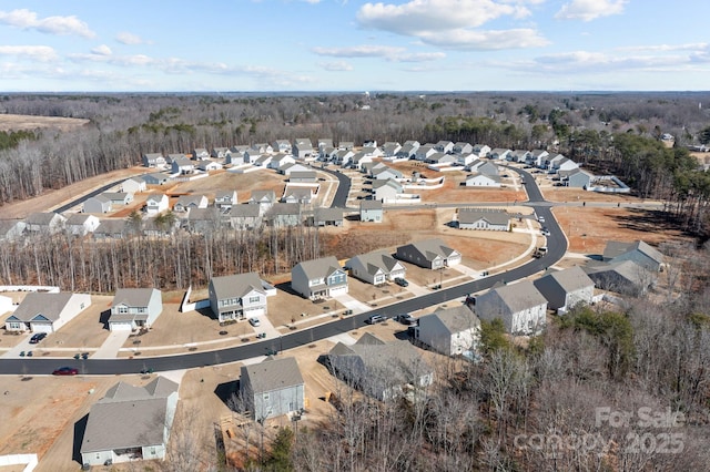 drone / aerial view with a residential view and a forest view