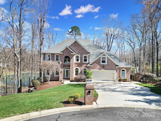 view of front of property with fence, an attached garage, a front lawn, concrete driveway, and brick siding