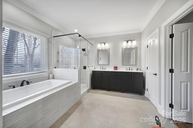 full bathroom featuring a sink, a shower stall, crown molding, a bath, and tile patterned floors