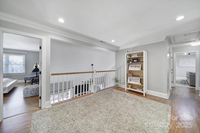 empty room featuring recessed lighting, baseboards, wood finished floors, and crown molding