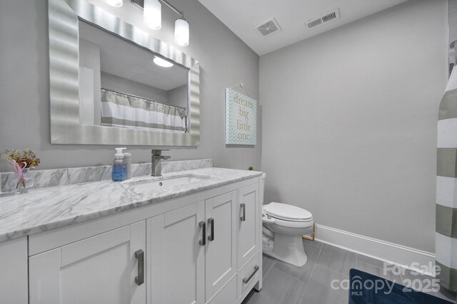 bathroom featuring vanity, toilet, baseboards, and visible vents