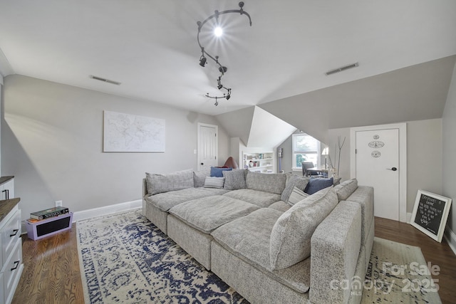 living area with lofted ceiling, baseboards, visible vents, and dark wood-style flooring