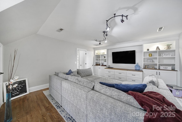 living area featuring visible vents, built in features, dark wood finished floors, baseboards, and lofted ceiling