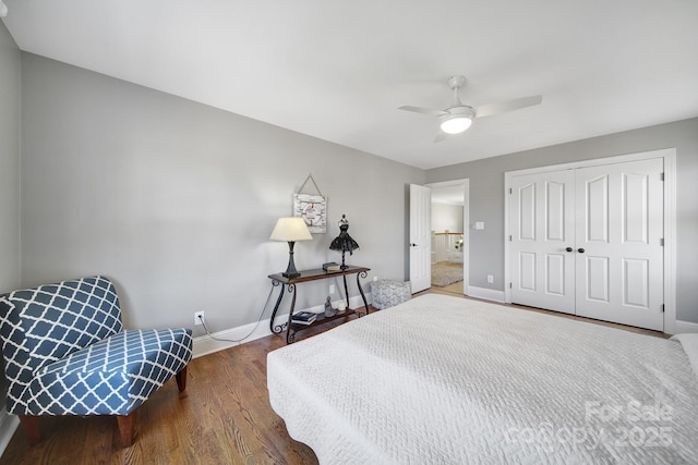 bedroom with a ceiling fan, wood finished floors, baseboards, and a closet