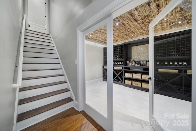 stairway with wooden ceiling and baseboards