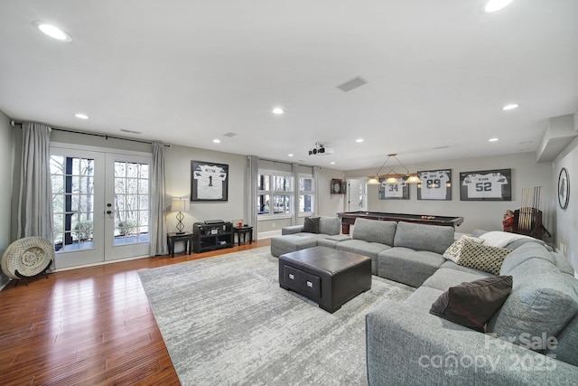 living room featuring recessed lighting, wood finished floors, visible vents, and french doors