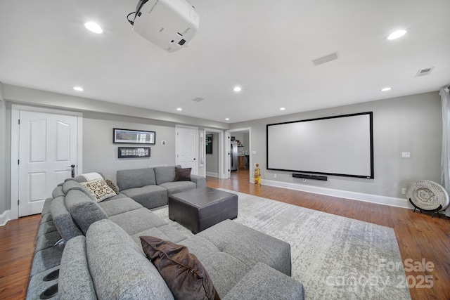 home theater featuring visible vents, recessed lighting, baseboards, and wood finished floors