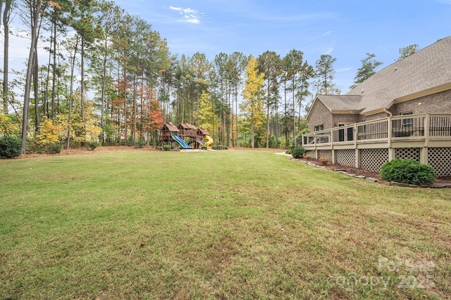 view of yard featuring a playground and a deck