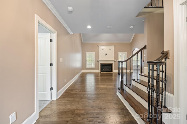 hall with recessed lighting, dark wood-type flooring, baseboards, stairs, and crown molding