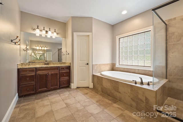 full bath with baseboards, tile patterned flooring, vanity, a shower stall, and a bath