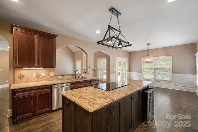 kitchen featuring a center island, pendant lighting, black electric stovetop, a sink, and dishwasher