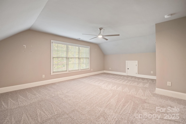 bonus room featuring light carpet, vaulted ceiling, and baseboards