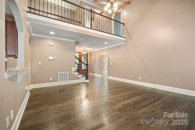 472 Barber Loop, Mooresville, NC 28117 - unfurnished living room featuring stairway, ornamental molding, visible vents, a ceiling fan, and a high ceiling