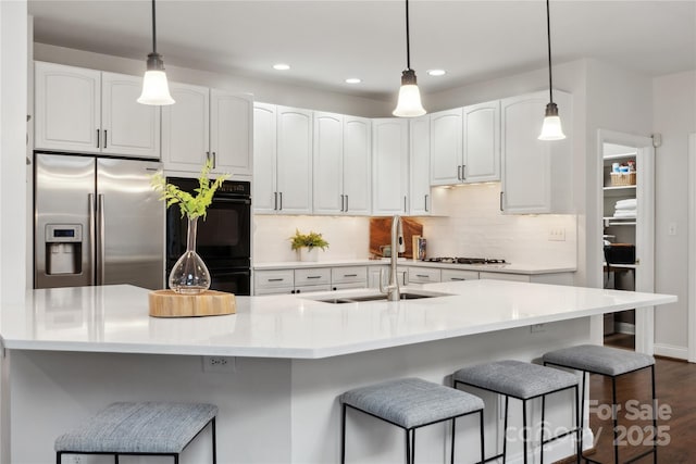 kitchen featuring light countertops, white cabinetry, and stainless steel fridge with ice dispenser