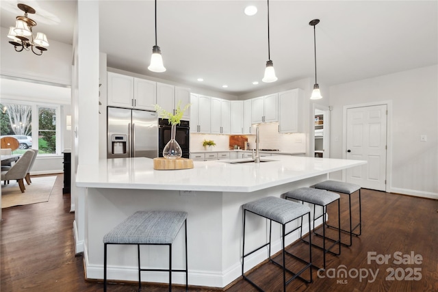 kitchen featuring white cabinetry, light countertops, and stainless steel fridge with ice dispenser