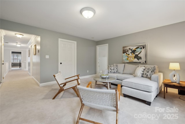 living room featuring light carpet and baseboards