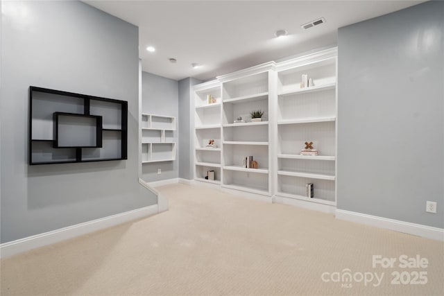 interior space with carpet floors, visible vents, and baseboards