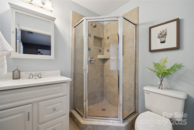 full bathroom with a shower stall, toilet, and vanity